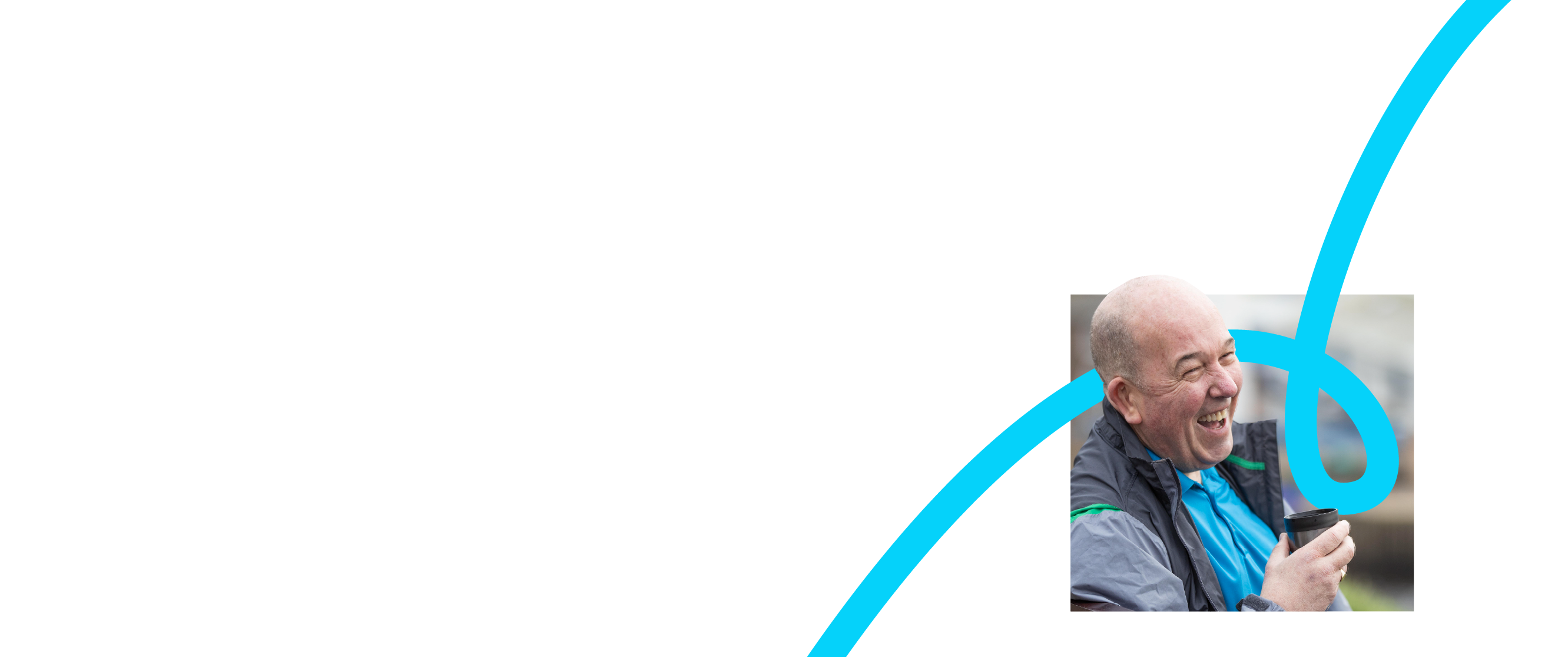 Photo of a smiling man holding a cup