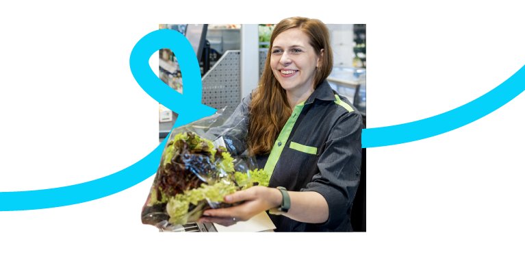 Smiling girl working at a supermarket check-out